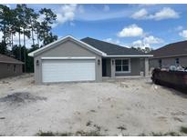 Charming single-story home with a two-car garage and well-manicured lawn at 7637 Sw 180Th Cir, Dunnellon, FL 34432