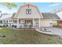 Charming two-story home with a landscaped yard and two-car garage on a sunny day at 8420 Sw 93 Ln # E, Ocala, FL 34476