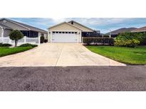 Charming single Gathering home featuring an attached garage and well-maintained landscaping at 3021 Beard Rd, The Villages, FL 32163