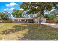 Charming single-story home with a well-maintained front yard and a cozy, covered front porch at 5005 Ne 22Nd Ave, Ocala, FL 34479