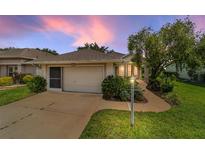 Charming single story home with a well-manicured lawn and 2 car garage at 5007 Kelso St, Leesburg, FL 34748