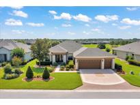 Beautiful single-story home boasts lush landscaping, a three-car garage, and a well-maintained lawn at 6683 Sw 97Th Terrace Rd, Ocala, FL 34481