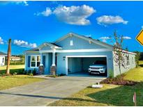 Charming home boasts a two-car garage, stylish stone accents, and manicured landscaping at 9253 Sw 58Th Cir, Ocala, FL 34476