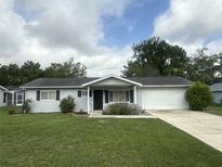 Charming single-story home with well-manicured lawn, attached garage, and inviting entrance at 11248 Sw 76Th Ter, Ocala, FL 34476