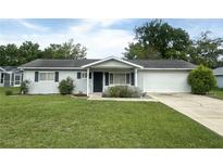 Charming single-story home with well-maintained lawn and attached one car garage at 11248 Sw 76Th Ter, Ocala, FL 34476