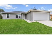 Charming single-story home featuring a well-manicured lawn and an attached one-car garage at 17277 Sw 44Th Cir, Ocala, FL 34473
