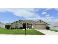 Charming single-story home featuring a well-manicured lawn and a two-car garage at 186 Nw 44Th St, Ocala, FL 34475