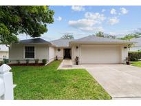 Charming single-story home with a well-manicured lawn, attached garage, and a freshly painted exterior at 2644 Sw 20 Cir, Ocala, FL 34471