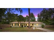 Charming one-story home featuring a well-maintained lawn and mature trees, creating a welcoming curb appeal at 3331 Se 4Th St, Ocala, FL 34471