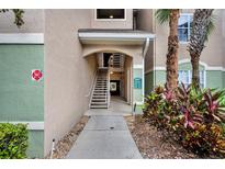 Exterior shot of building entrance with stairway and landscaping at 4897 Cypress Wood Dr # 6313, Orlando, FL 32811