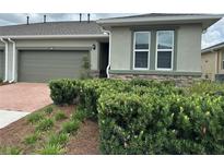 Charming home with a well-manicured lawn and a two-car garage, offering curb appeal and convenience at 5255 Nw 33Rd Pl, Ocala, FL 34482