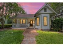 Charming home with a welcoming front porch and a brick path leading to the entrance at 828 Se 3Rd St, Ocala, FL 34471