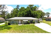 Charming single-story home boasts a well-manicured lawn, colorful landscaping, and a welcoming front entrance at 2810 Se Lake Weir Ave, Ocala, FL 34471