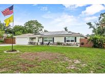 Charming single-story home with a well-manicured lawn, solar panels, and a welcoming front porch at 460 E Haines Blvd, Lake Alfred, FL 33850