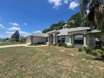 Charming single-story home with mature trees and well-maintained lawn and a front entry two car garage at 8100 Sw 56Th Ter, Ocala, FL 34476