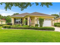 Charming single-story home with well-maintained landscaping and a lush green lawn at 9551 Sw 92Nd Ter, Ocala, FL 34481