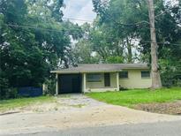 Modest single-story home featuring a covered carport and small front lawn at 1051 Se 28Th Rd, Ocala, FL 34471
