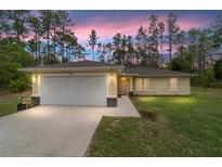 Charming yellow single-story home with a two-car garage and well-maintained lawn at 13131 Sw 73Rd St, Ocala, FL 34481