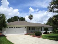 Charming single-story home featuring an attached garage, well-maintained landscaping, and inviting curb appeal at 14695 Sw 112Th Cir, Dunnellon, FL 34432