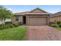 Charming single-Gathering home boasting a brick driveway and a two-car garage at 5587 Nw 40Th Pl, Ocala, FL 34482