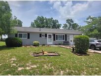 Charming single-story home featuring a well-manicured lawn and inviting front porch at 8343 Sw 105Th Pl, Ocala, FL 34481