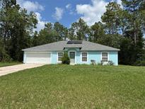 Charming single-story home featuring an attached garage, a well-maintained lawn, and mature trees at 13155 Sw 73 Ave, Ocala, FL 34473