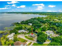 Expansive lakefront property with lush greenery and a private waterfront setting in a desirable neighborhood at 15621 Se 103Rd Ter, Summerfield, FL 34491