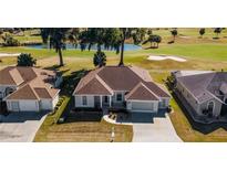 Well-maintained single-story home near a golf course, with manicured landscaping and an attached two-car garage at 2515 Nw 53 Ave, Ocala, FL 34482