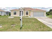 Charming home featuring a well-maintained lawn, inviting curb appeal, and an attached two-car garage at 5551 Nw 25Th Loop, Ocala, FL 34482