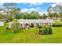 Charming one-story home with a well-manicured lawn, mature trees and tasteful landscaping at 616 Se 40Th Ave, Ocala, FL 34471