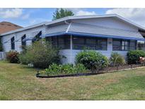 Charming single-story home with a well-maintained lawn and tidy landscaping at 741 Truman Ave, Lady Lake, FL 32159