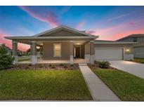 Charming single-story home showcasing a covered porch, neutral color scheme, and well-manicured lawn at 7745 Sw 56Th Pl, Ocala, FL 34474