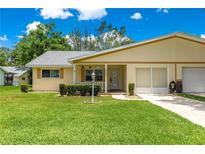 Charming single-story home with a well-manicured lawn, covered porch, and attached garage at 8625 Sw 94Th Ln # A, Ocala, FL 34481