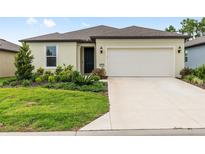 Charming single-story home with a well-manicured lawn and a two-car garage at 8989 Sw 57Th Place Rd, Ocala, FL 34481