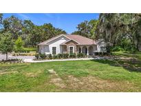 An eye-level exterior view of the house with manicured lawn at 15620 Nw 112Th Ave, Reddick, FL 32686