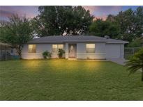 Charming single-story home with a well-maintained lawn and inviting front entrance at dusk at 18 Banyan Pass, Ocala, FL 34472