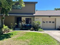 Charming home with a well-manicured lawn and a cozy front porch featuring unique seating at 3833 Ne 17Th Street Cir, Ocala, FL 34470