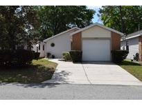 Charming single-story home featuring a brick facade, a two-car garage, and a well-maintained front yard at 3904 Ne 22Nd St, Ocala, FL 34470