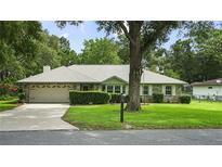 Charming single-story home featuring a well-maintained front yard and an attached two-car garage at 8205 Sw 100Th Lane Rd, Ocala, FL 34481