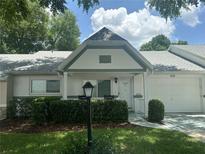Charming single-story home featuring manicured landscaping, attached garage, and covered entryway at 9255 Sw 90Th Ct # B, Ocala, FL 34481