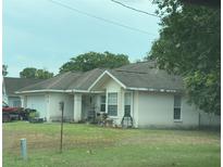 Cozy single-story home with a well-maintained lawn and attached garage at 22 Banyan Trak, Ocala, FL 34472