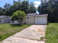 Charming single-story home with a well-maintained lawn and a one-car garage at 2426 Maple Ave, Sanford, FL 32771
