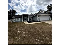 Charming single-story home with a well-manicured lawn and a two-car garage at 2550 Sw Ivy Pl, Dunnellon, FL 34431