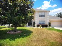 Charming two-story home with a well-manicured lawn and beautiful landscaping at 3223 Sw 41St Ave, Ocala, FL 34474