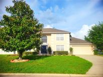 Charming two-story home with a well-manicured lawn and beautiful landscaping at 3223 Sw 41St Ave, Ocala, FL 34474