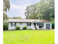 Charming single-story home featuring fresh exterior paint, dark shutters and a lush green lawn at 3610 Sw 25Th Pl, Ocala, FL 34474