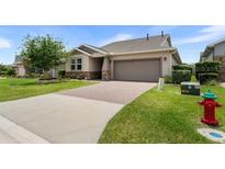 Charming one-story home with a well-maintained lawn and a two-car garage at 4232 Nw 56Th Ct, Ocala, FL 34482