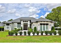 Stunning home featuring a manicured lawn, detailed trim, and an inviting front entrance at 5845 Sw 43Rd Street Rd, Ocala, FL 34474