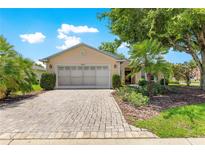 Charming single-story home with a brick driveway and lush, manicured landscaping at 8034 Sw 81St Loop, Ocala, FL 34476
