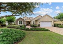Charming single-story home with stone accents, lush landscaping, and a brick driveway at 8611 Sw 83Rd Loop, Ocala, FL 34481